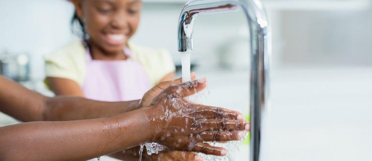 Girl and mom washing hands